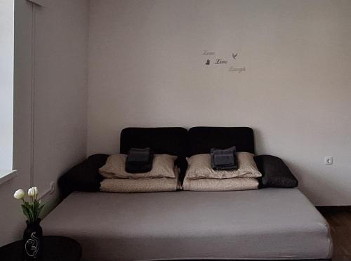 a bed in a room with two pillows on it at Maestro I. in Laško