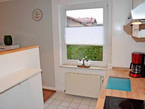 a kitchen with a sink and a window at Ferienwohnung Gartenblick in Altefähr