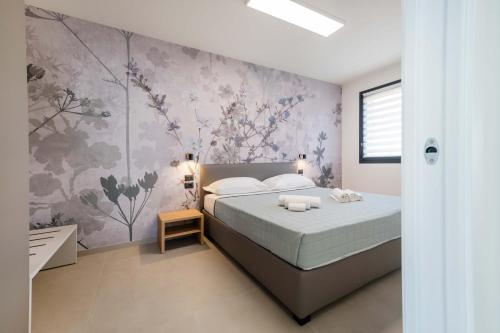 Ένα ή περισσότερα κρεβάτια σε δωμάτιο στο ApartmentsGarda - I Fiori D'Ulivo