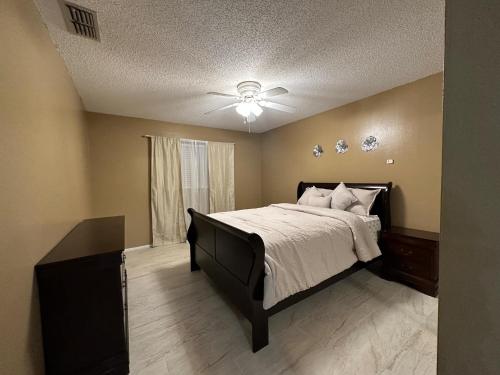 a bedroom with a bed and a ceiling fan at Dream home in Port Richey