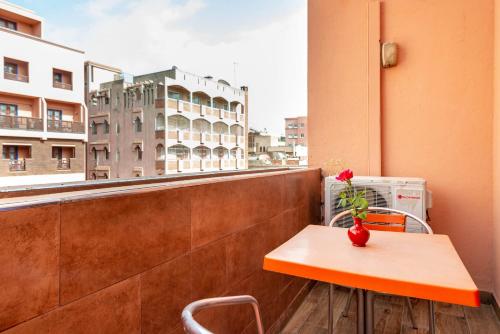 a table on a balcony with a view of a building at Hotel Oudaya & Spa in Marrakech