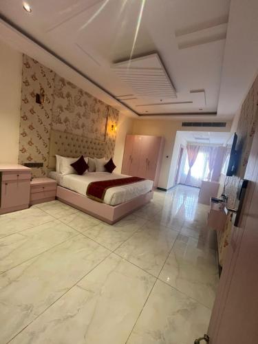 a bedroom with a bed in a room at Hotel Yathin in Mysore