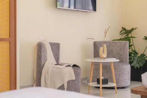 a living room with two chairs and a table at Thé Villa in Da Lat
