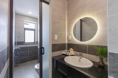 a bathroom with a sink and a mirror at Thé Villa in Da Lat