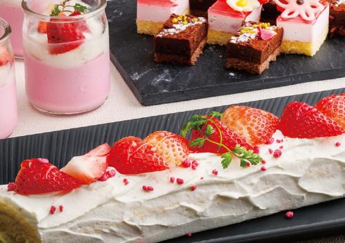 two plates of desserts with strawberries and a pink drink at Hotel Monterey Okinawa Spa & Resort in Onna