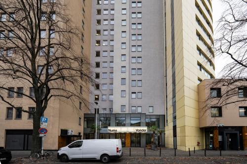 a white van parked in front of a building at Numa Berlin Potsdamer Platz in Berlin