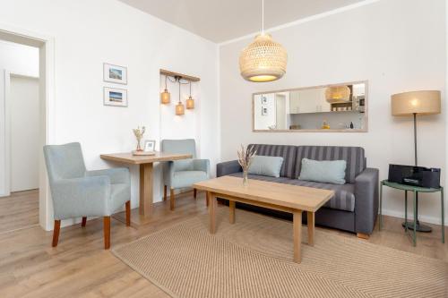 a living room with a couch and a table at Apartments an Sankt Marien in Stralsund