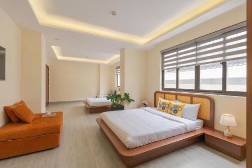 a bedroom with a large bed and a chair at Thé Villa in Da Lat