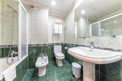 a bathroom with a sink and a toilet at Port Europa in Calpe