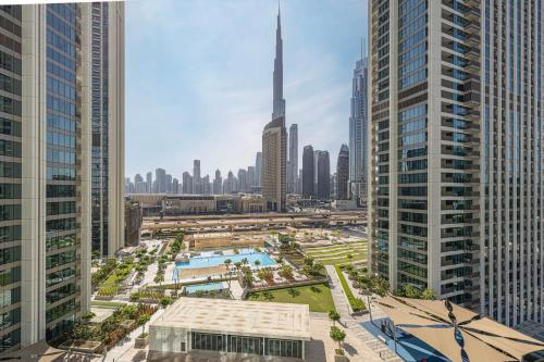an aerial view of a city with tall buildings at Dubai Mall Connected! AMAZING Burj Khalifa View! Excellent Pool & Gym Access! in Dubai