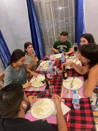 a group of people sitting around a table eating at Local Villa Lodge in Arusha