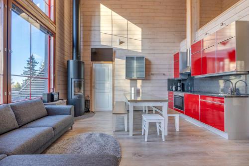 a kitchen with a couch and a table in a room at Holiday Apartments Kruunurinne 1 & 2 in Himos