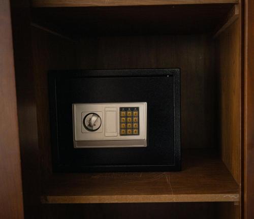 a microwave oven in a shelf in a cabinet at Aster Hotel in Jeddah