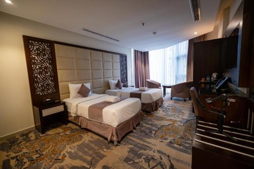 Postel nebo postele na pokoji v ubytování Aster Hotel
