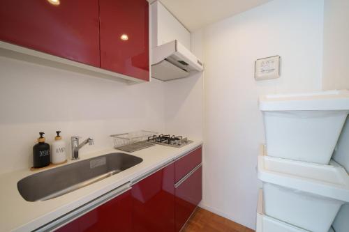 a kitchen with red cabinets and a sink at Space Roppongi in Tokyo