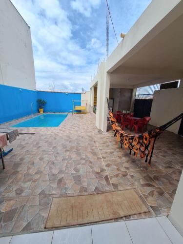 a patio with a swimming pool on a building at Rancho da Nice in Presidente Epitácio