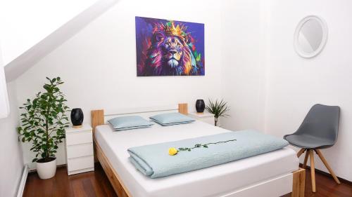 a bedroom with a bed with a painting on the wall at Jacky & Daniel's Apartments Top 2 in Sankt Pölten