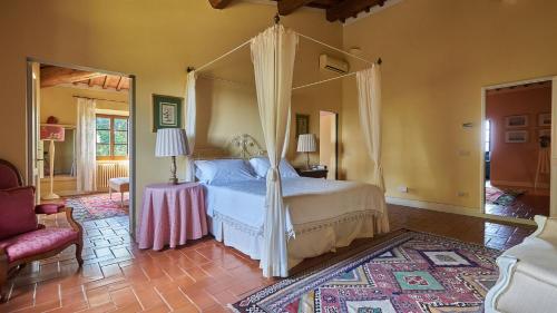 a bedroom with a bed with a canopy at Villa Marliana in Cerreto Guidi