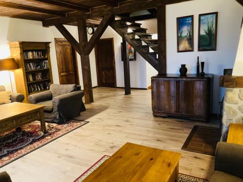 a living room filled with furniture and a table at Modryna - Modrzewiowy Dom in Cisna