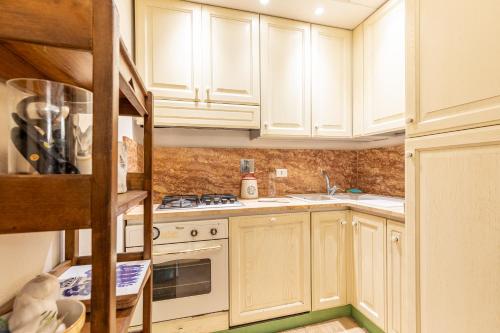 a kitchen with white cabinets and a stove top oven at La Terrazza, Cetona, Toscana in Cetona