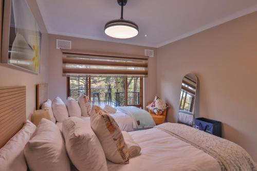 a bedroom with a large bed with white pillows at Cornerstone Connection in Durban