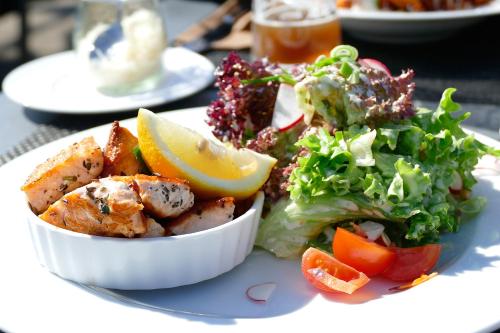 a plate with a salad and a bowl of food at Hotel Engel Buch in Albbruck