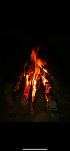 a fire burns in a fire pit at night at Villa Marlene Casa vacanze in parco privato in Monterusciello
