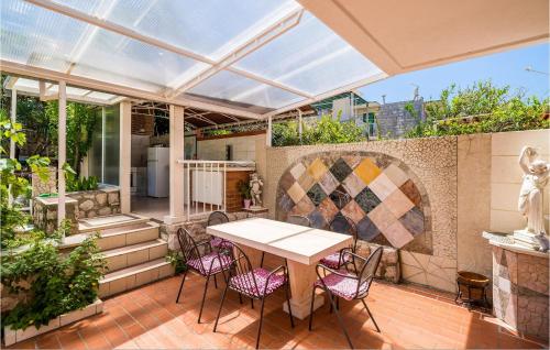 an outdoor patio with a table and chairs at Nice Apartment In Zaton Veliki With Wifi in Zaton