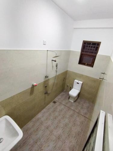 a bathroom with a toilet and a sink at Sandakini Home Rest in Ahangama