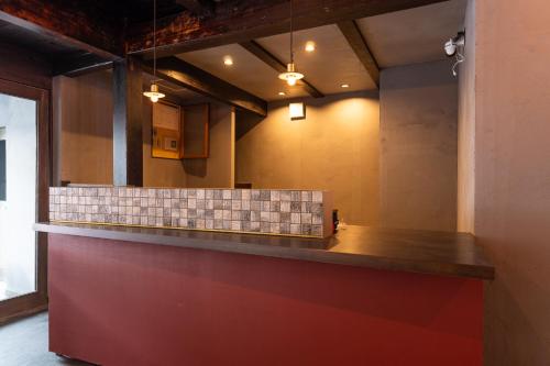 a bar in a restaurant with a tile counter at 源泉掛け流し温泉Villa The ITAYA in Yuzawa
