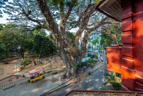 a view of a street with a tree and a yellow truck at Koder House in Cochin