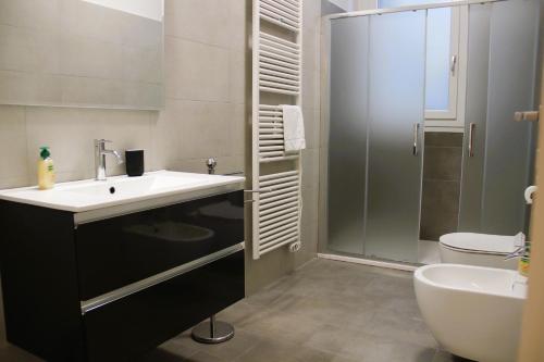 a bathroom with a sink and a shower and a toilet at Suite Turati in Casalecchio di Reno