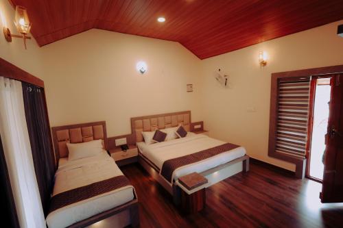 a bedroom with two beds and a window at Mountain Peak Resort in Hassan