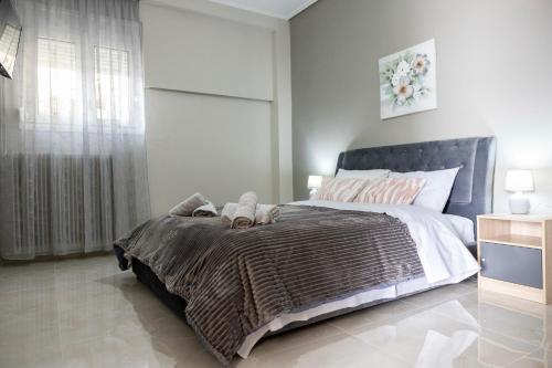 a bedroom with a large bed with two stuffed animals on it at Valia's House in Kalabaka