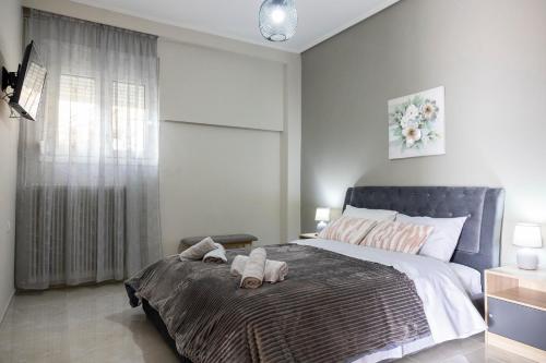 a bedroom with a bed with two stuffed animals on it at Valia's House in Kalabaka