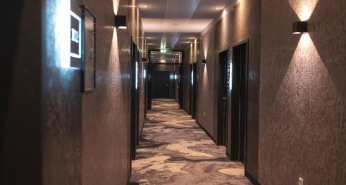 a hallway of a building with a long corridor at PLAZA Premium Heidelberg in Heidelberg