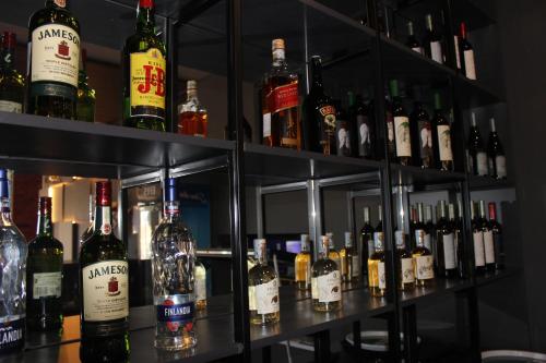 a shelf filled with lots of bottles of alcohol at Luxor Rabath in Akhaltsikhe