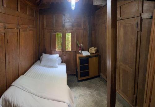 a small room with a bed and a telephone at Homestay Omah Embun in Godean