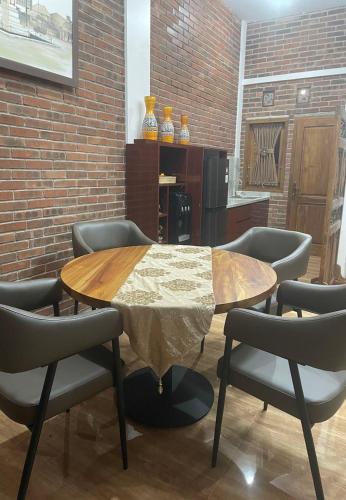 a dining room with a table and chairs at Homestay Omah Embun in Godean