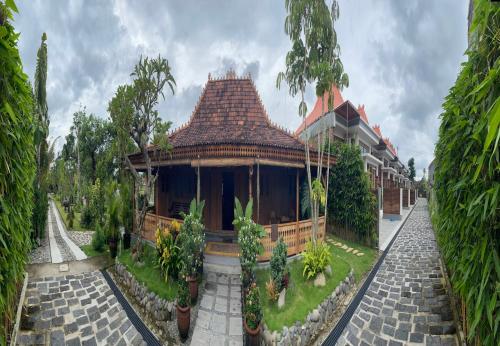 a house with a tile roof and a courtyard at Homestay Omah Embun in Godean