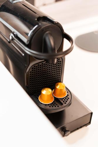 a toaster oven with two goldenumbs on top of it at La Chicca in pieno centro storico con SAUNA e Parcheggio gratuito in Udine