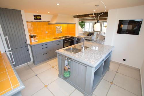 a kitchen with a sink and a counter top at Awesome Home In Vessigebro With 2 Bedrooms And Wifi in Vessigebro
