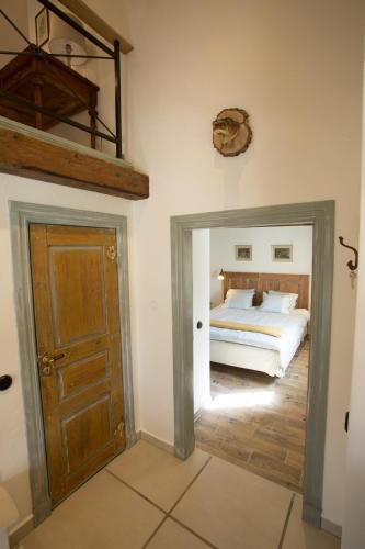 a bedroom with a bed and a wooden door at Awesome Home In Vessigebro With 2 Bedrooms And Wifi in Vessigebro