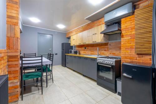 a kitchen with a table and a stove top oven at 4Season Villa in Tbilisi City