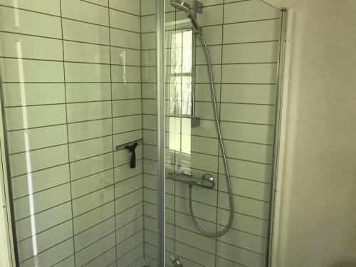 a shower in a bathroom with a glass door at Only 400 Meters From The Water Is This Lovely And Cozy Holiday Home In A Lovely Area, in Hundested