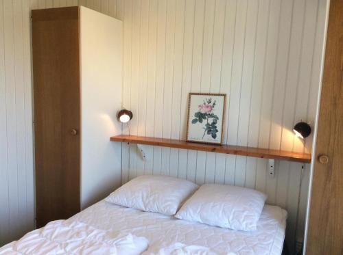 a bedroom with a bed with a shelf on the wall at Awesome Home In Rønde With 3 Bedrooms in Rønde
