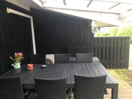 a wooden table and chairs on a patio at Awesome Home In Rønde With 3 Bedrooms in Rønde