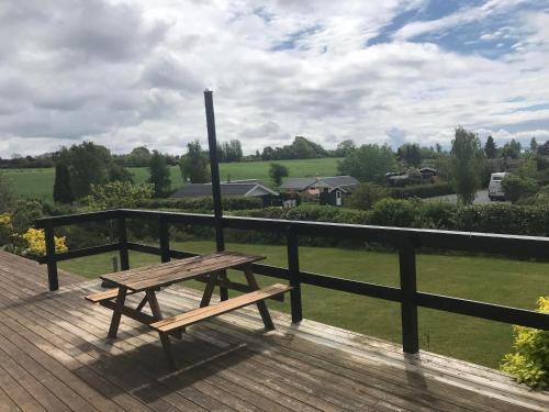 a wooden bench sitting on top of a wooden deck at Awesome Home In Rønde With 3 Bedrooms in Rønde