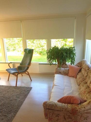 a living room with a couch and a chair at Amazing Home In Jonstorp With 1 Bedrooms in Jonstorp