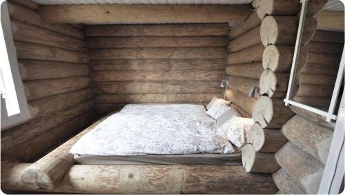 a bedroom with a bed in a wooden wall at Amazing Home In Sälen With 5 Bedrooms, Sauna And Wifi in Sälen